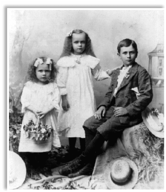 A man and two girls in white dresses.