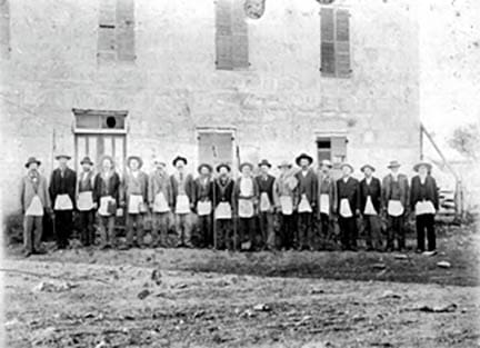 A group of men standing in front of a building.