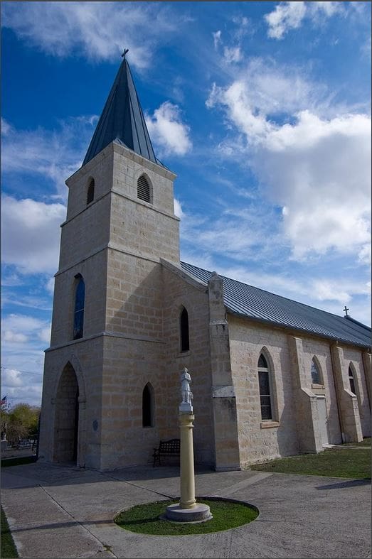 A large church with a steeple and a clock tower.