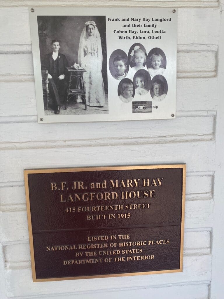 A plaque with an image of the family and a picture of them.